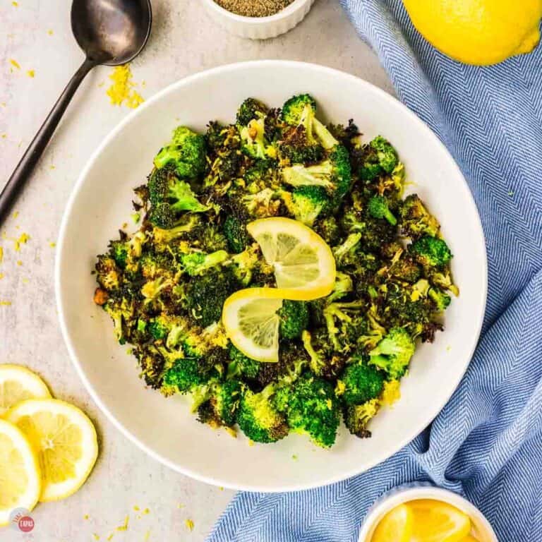 plate of broccoli with a lemon slice on top