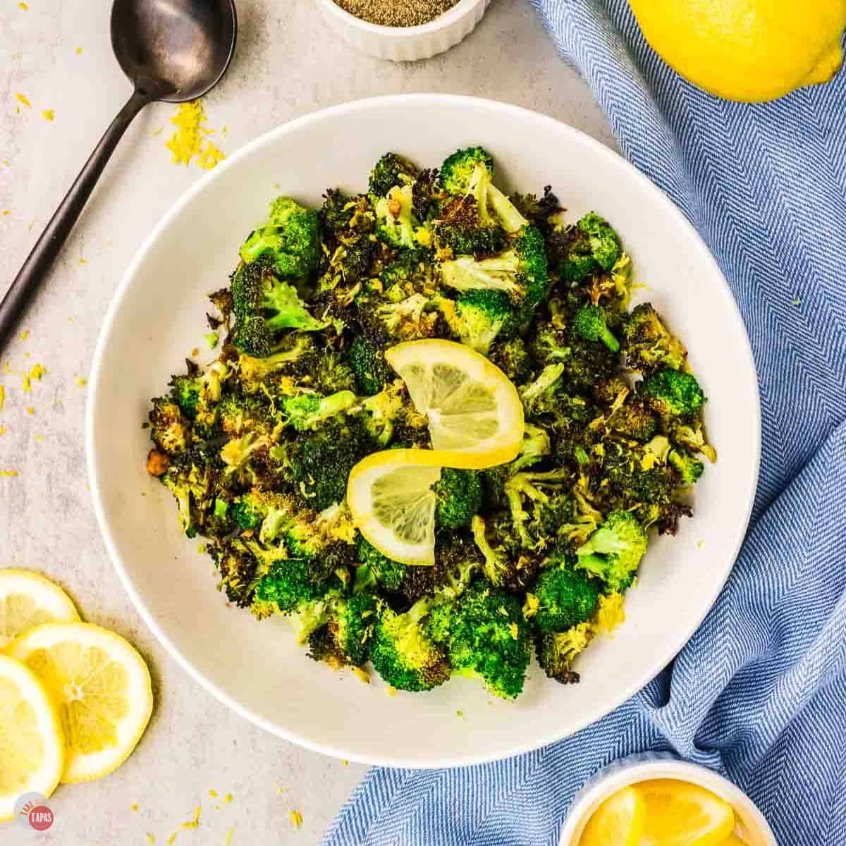 plate of broccoli with a lemon slice on top