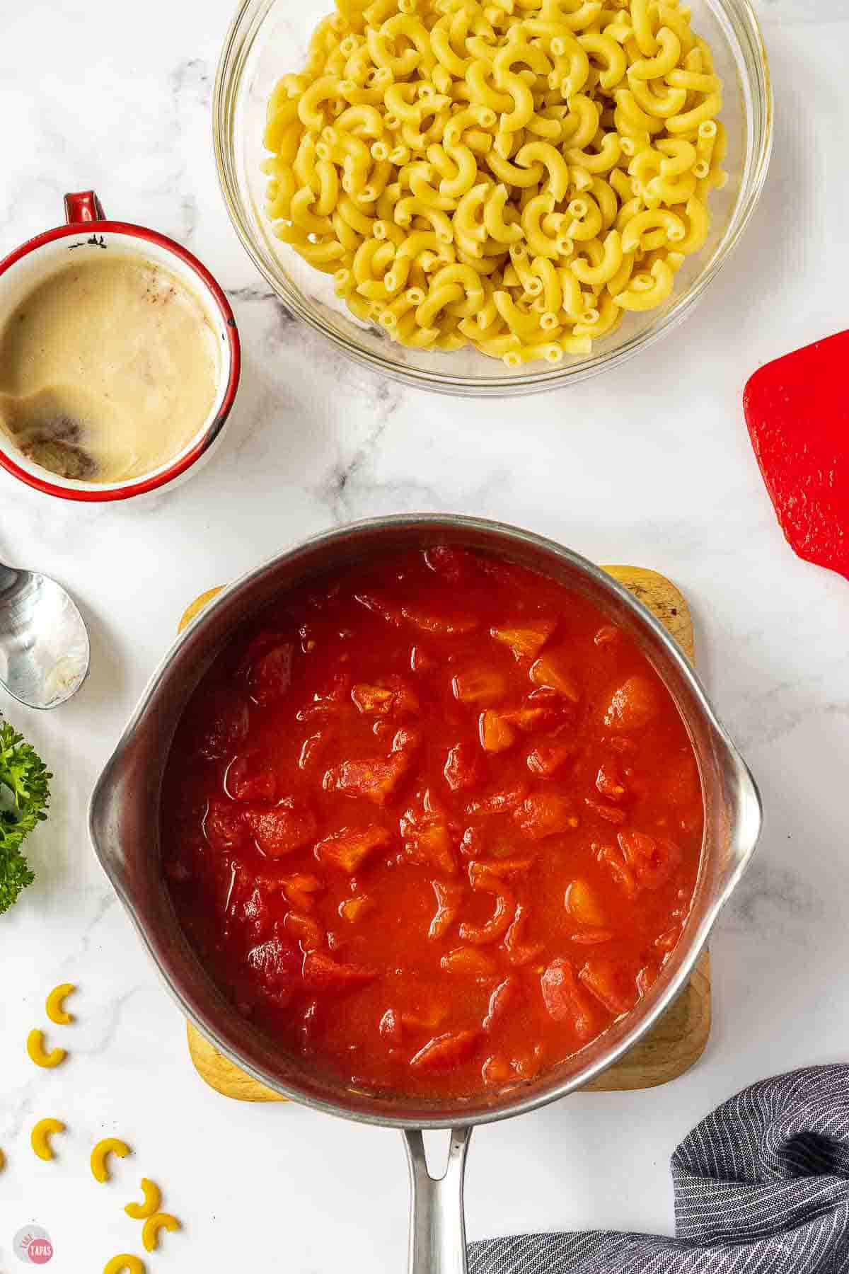 stewed tomatoes cooking in a silver pot
