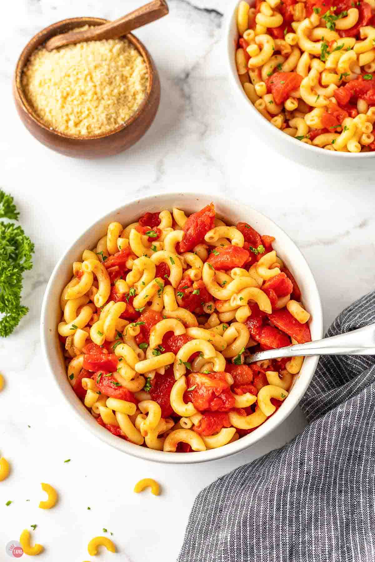 bowl of elbow macaroni with stewed tomatoes and cheese
