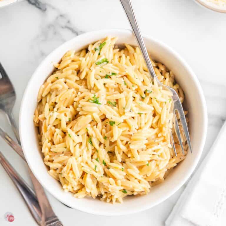 bowl of parmesan orzo with a spoon