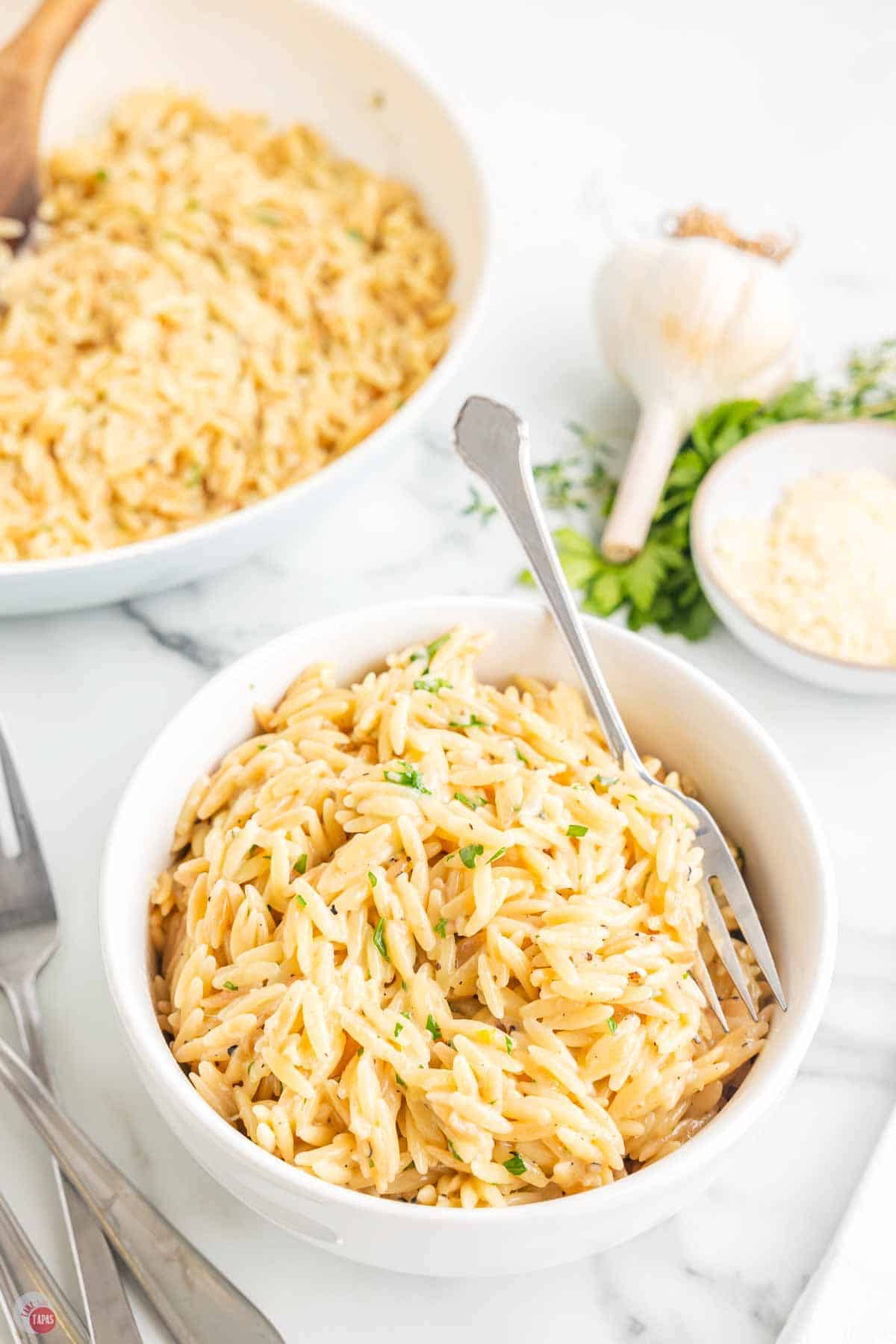 bowl of parmesan orzo with a spoon