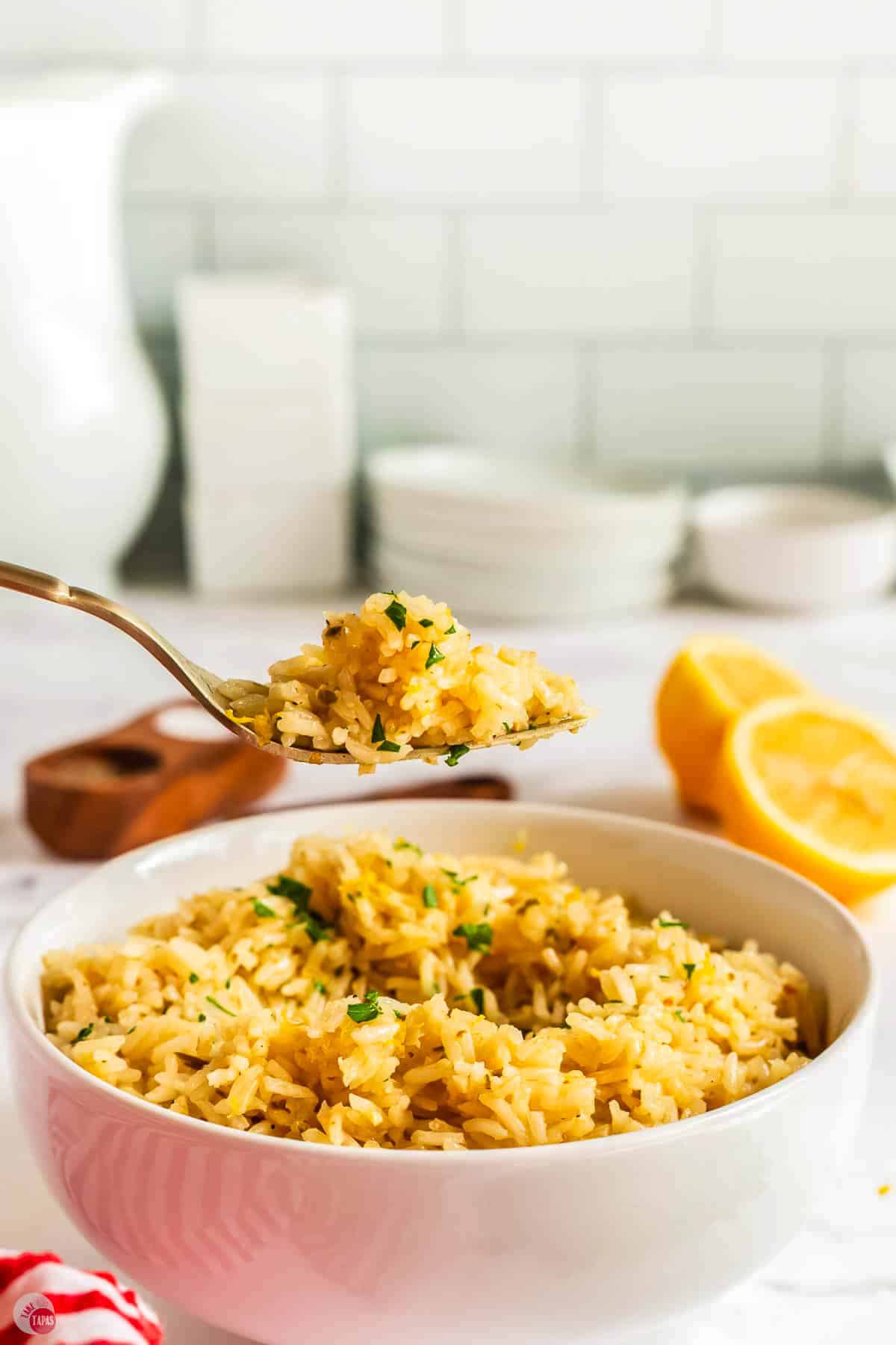 fork hovering above a bowl with rice on it