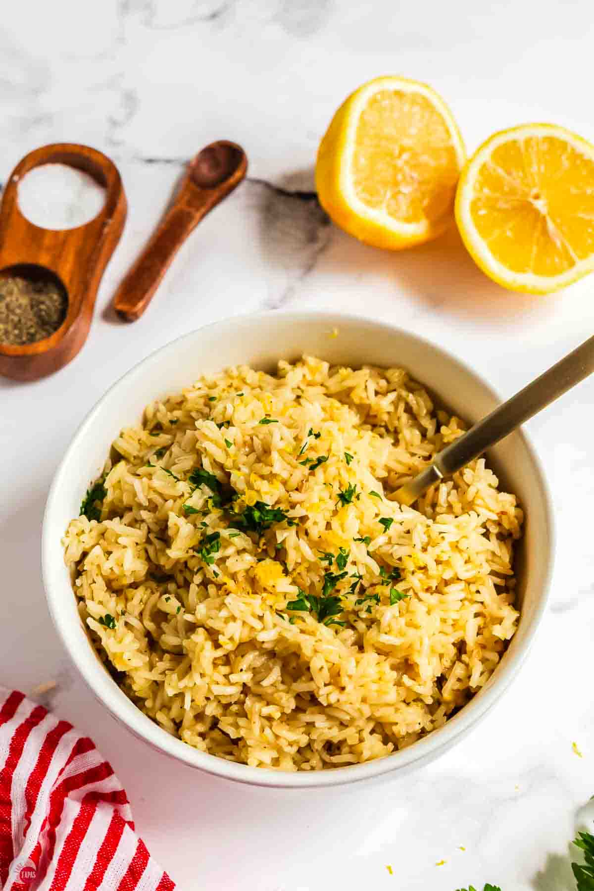 bowl of pesto rice with lemon slices