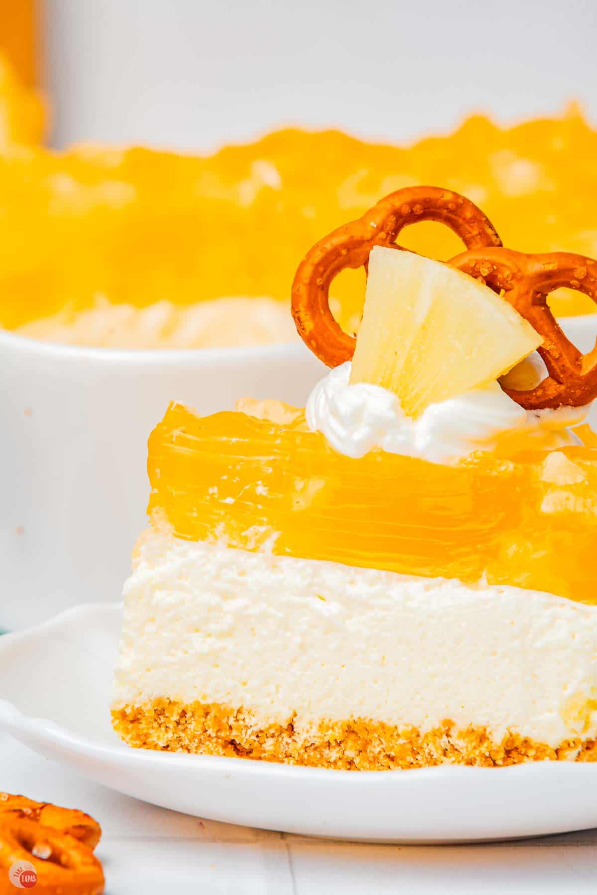 close up of side view of pineapple pretzel salad on a plate