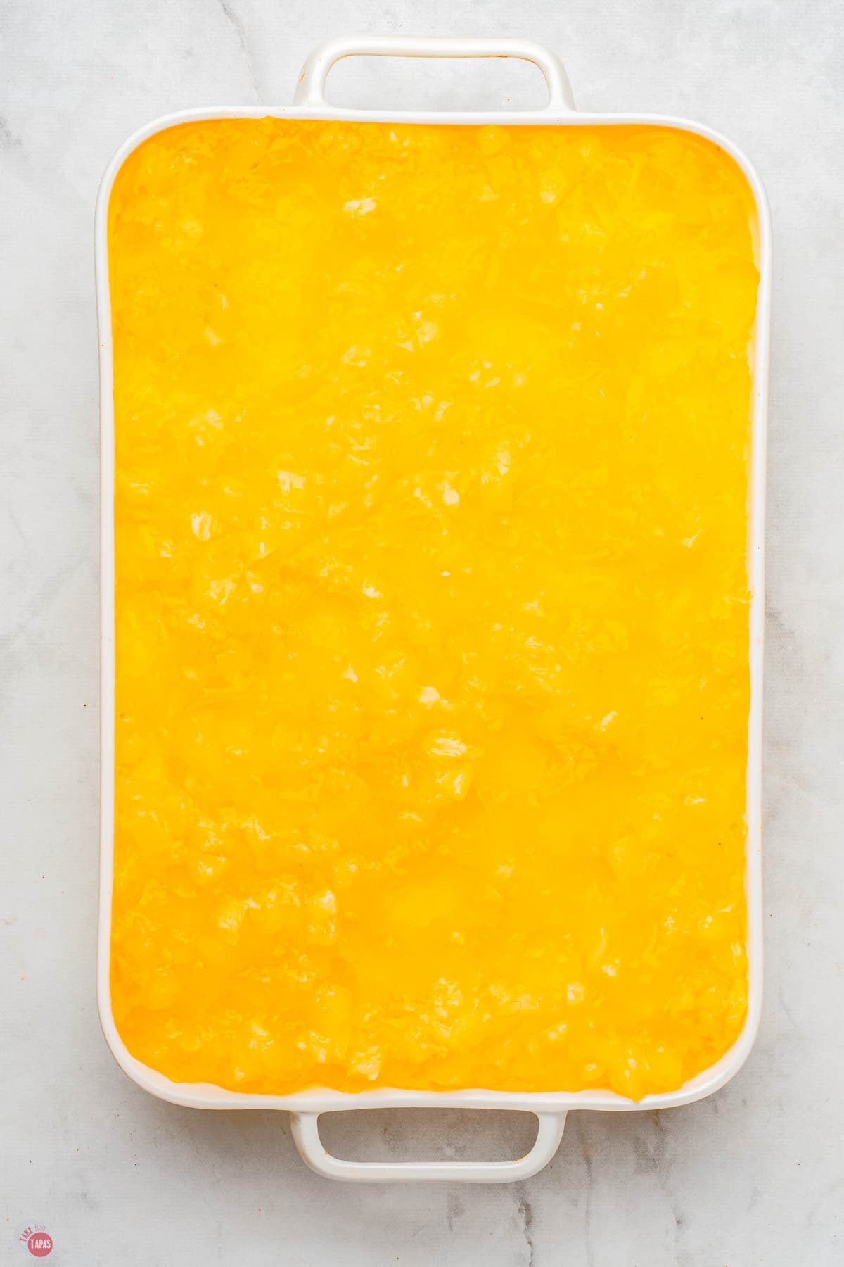 pineapple pretzel salad layered in a casserole dish