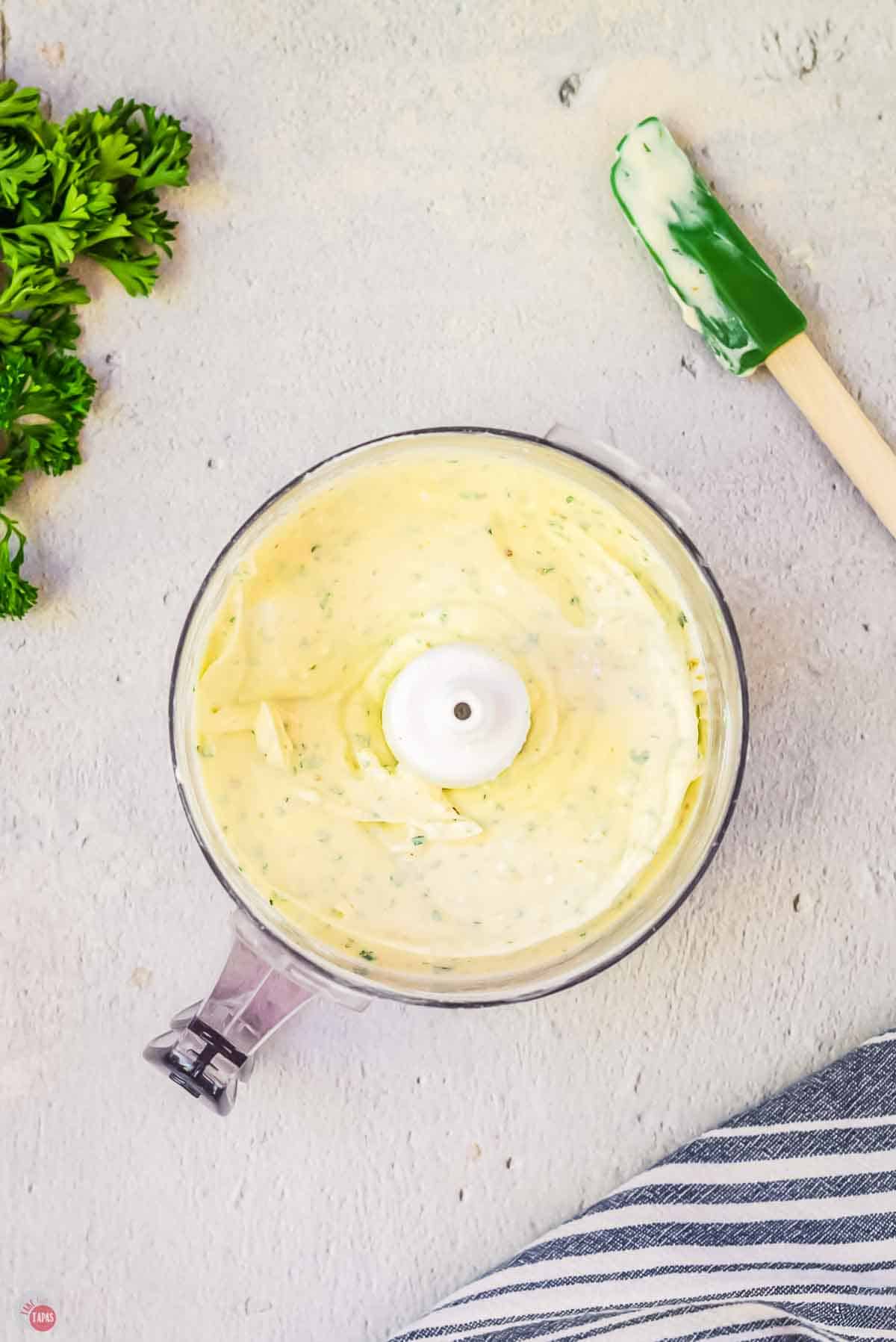 cheeses being whipped in a food processor
