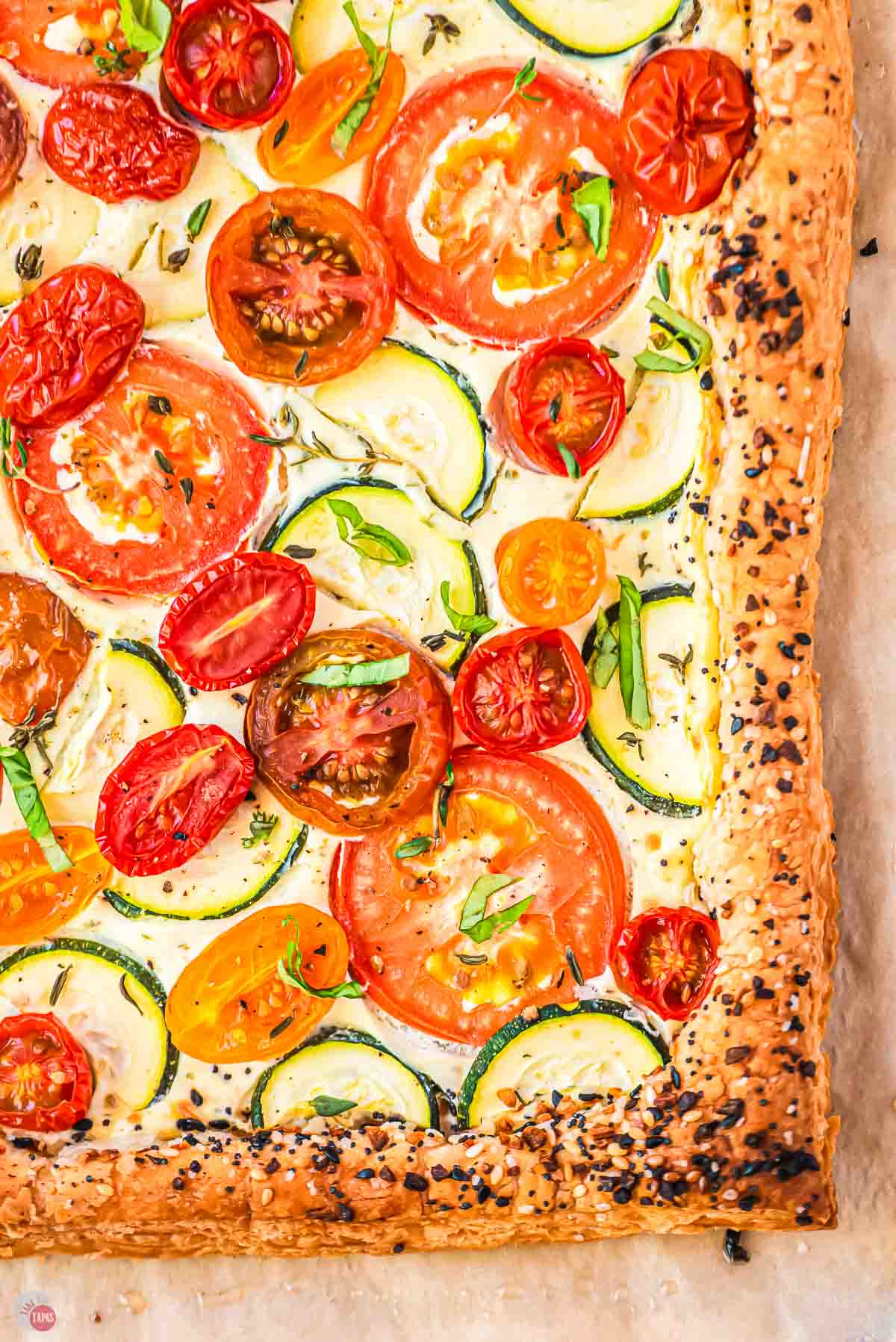 close up of puff pastry tart with tomatoes and zucchini