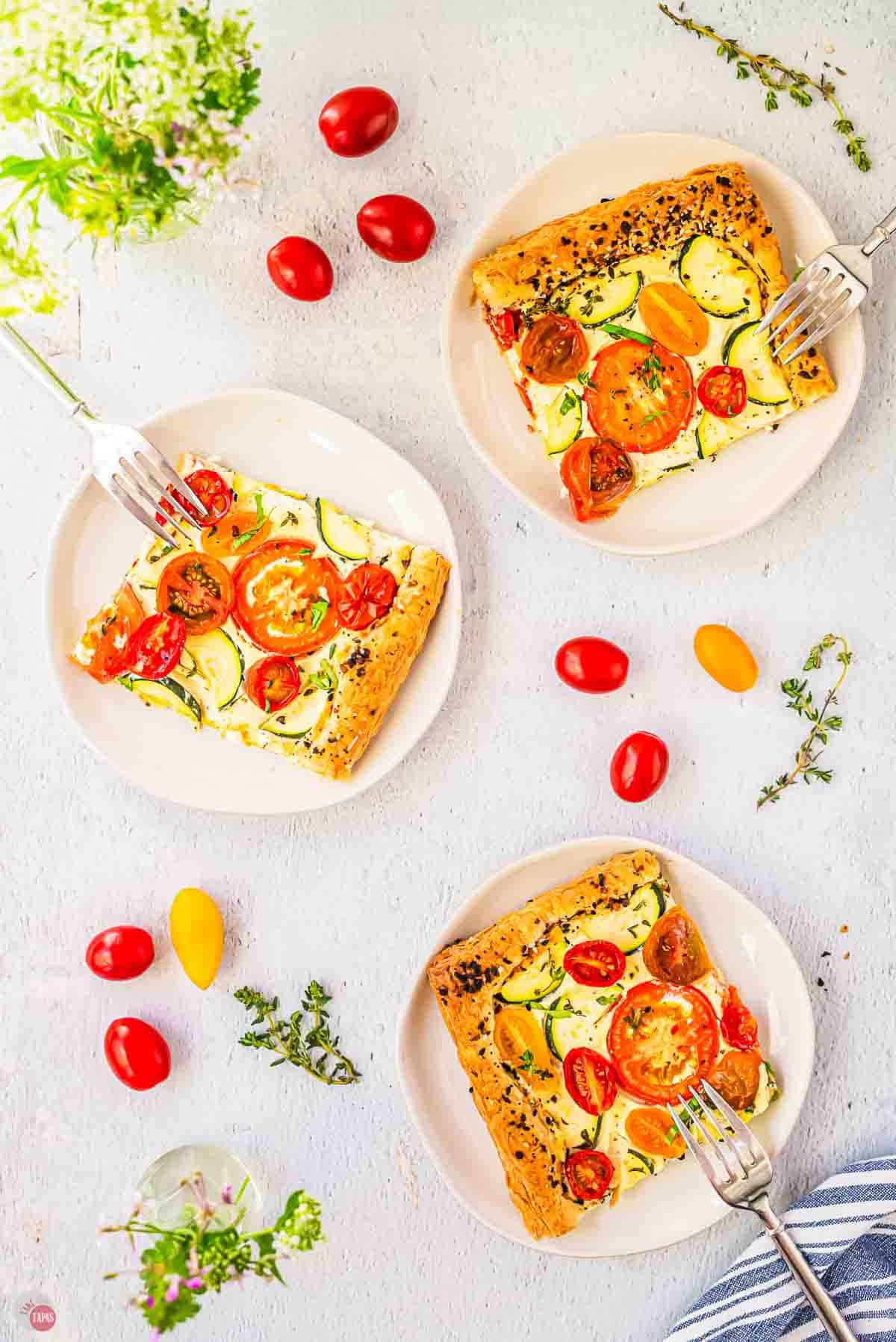 three white plates with slices of tomato part on them