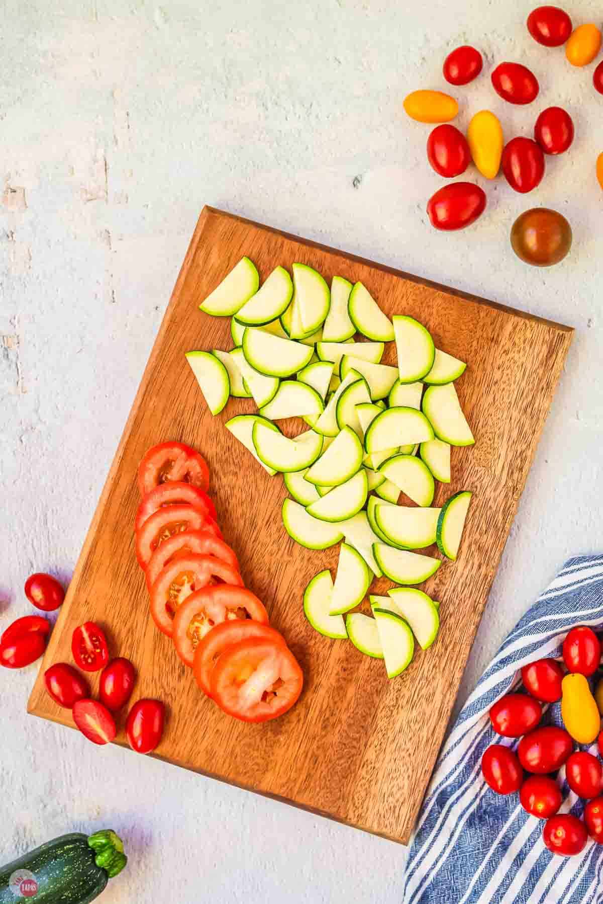tomatoes and zucchini sliced on a cutting board