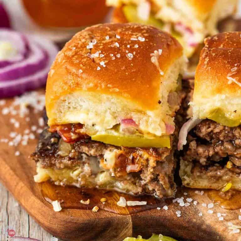 smash burger sliders on a small wood board