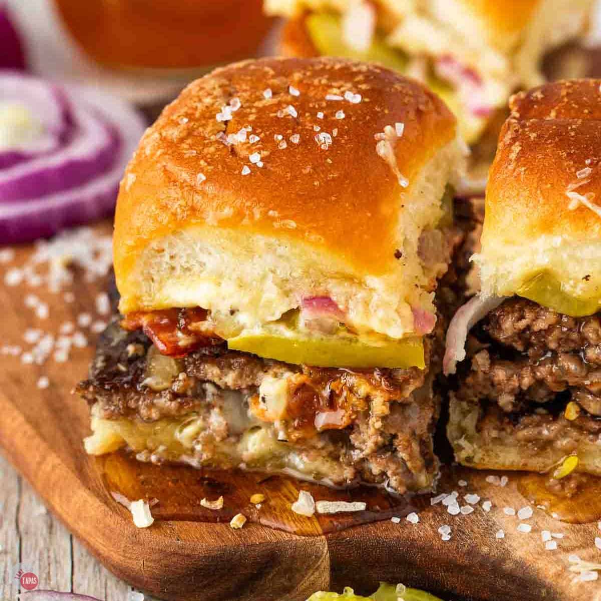 smash burger sliders on a small wood board