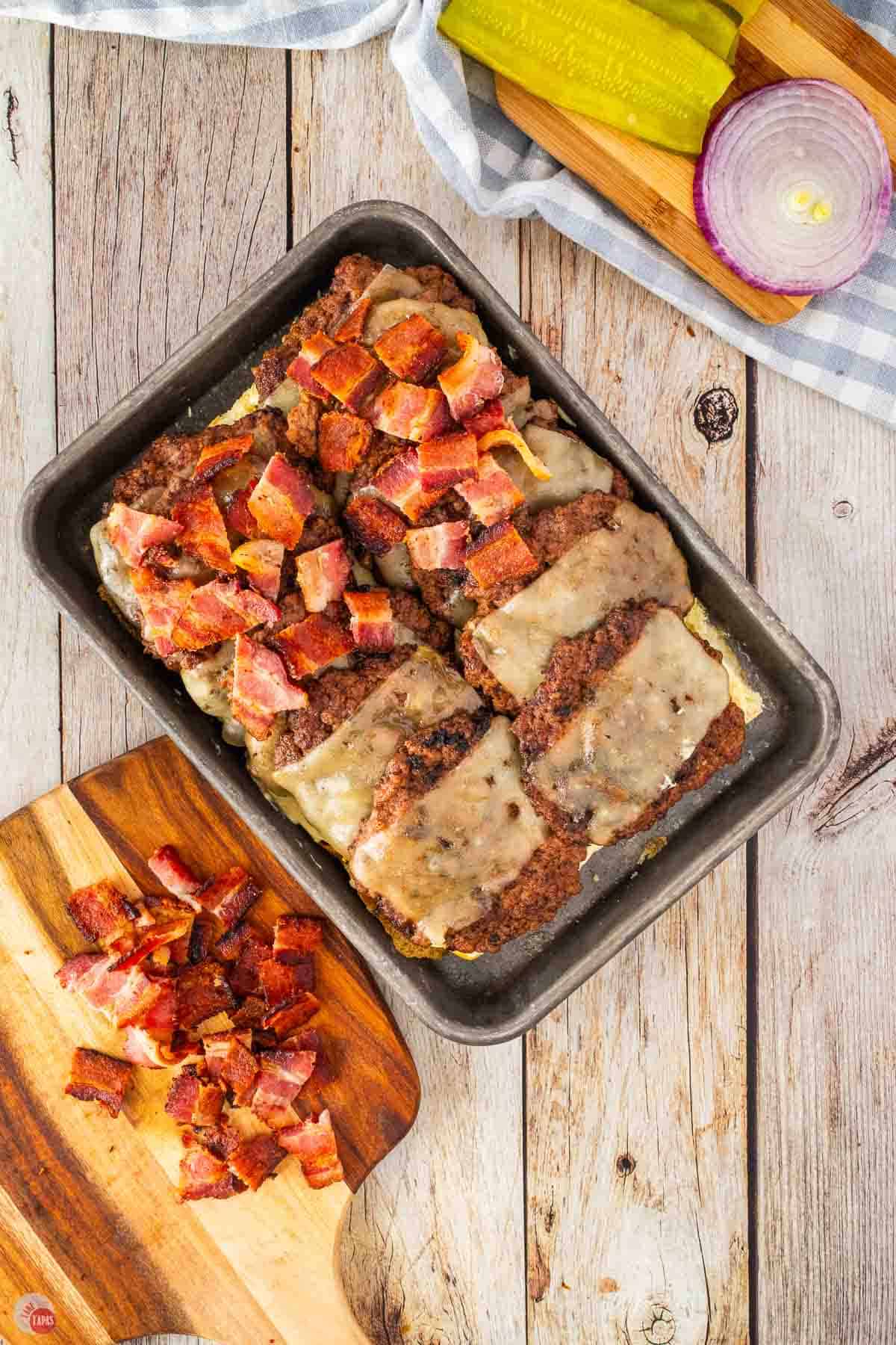 baking sheet topped with buns and burger patties