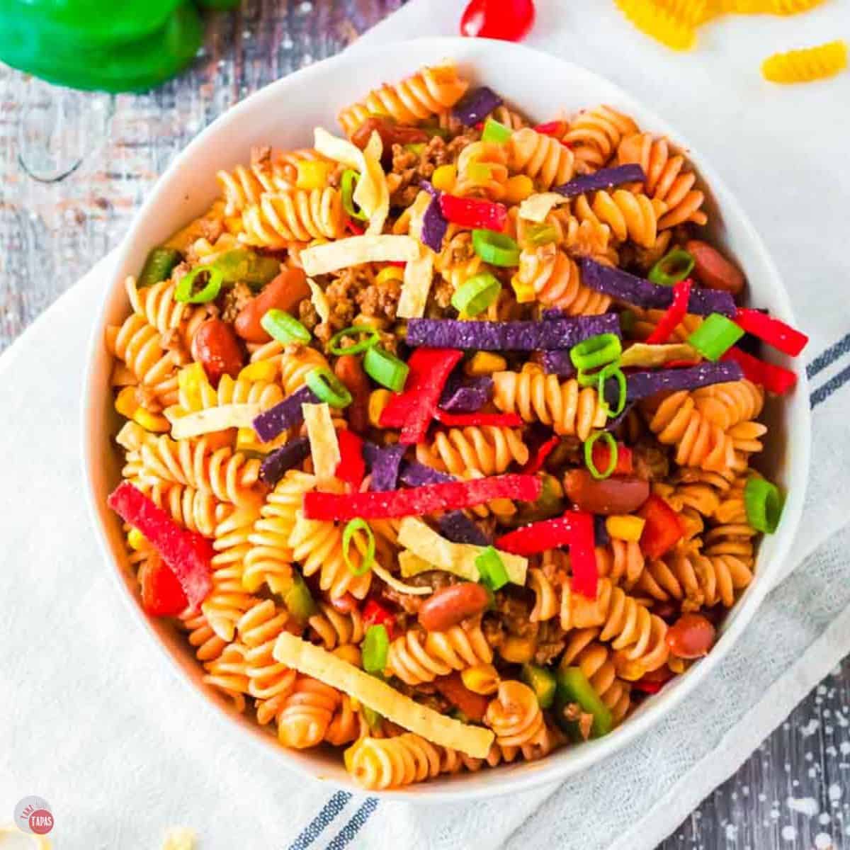 overhead picture of a bowl of taco pasta salad with colored tortilla strips