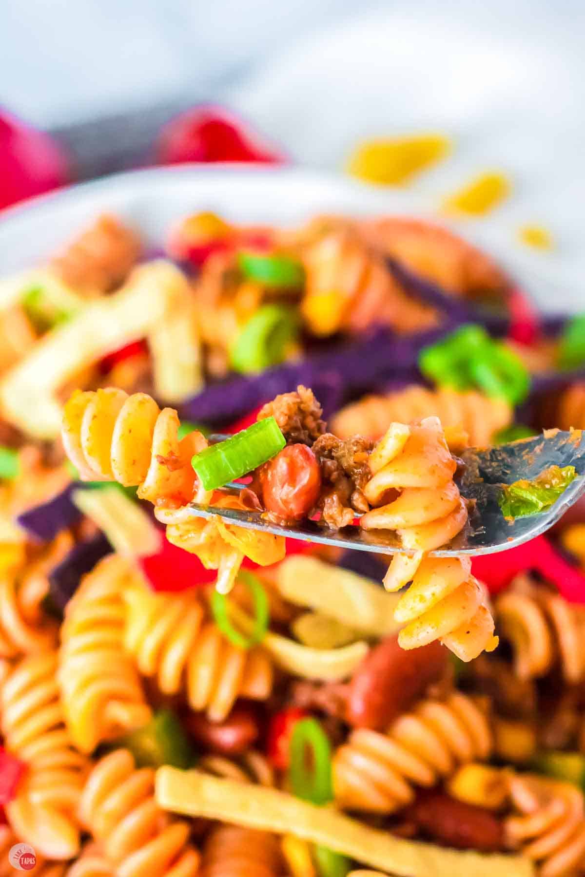close up of fork with pasta and taco meat
