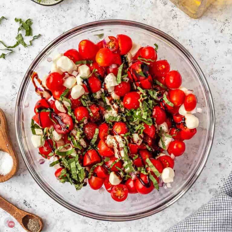 clear bowl of tomato, mozzarella, and fresh basil