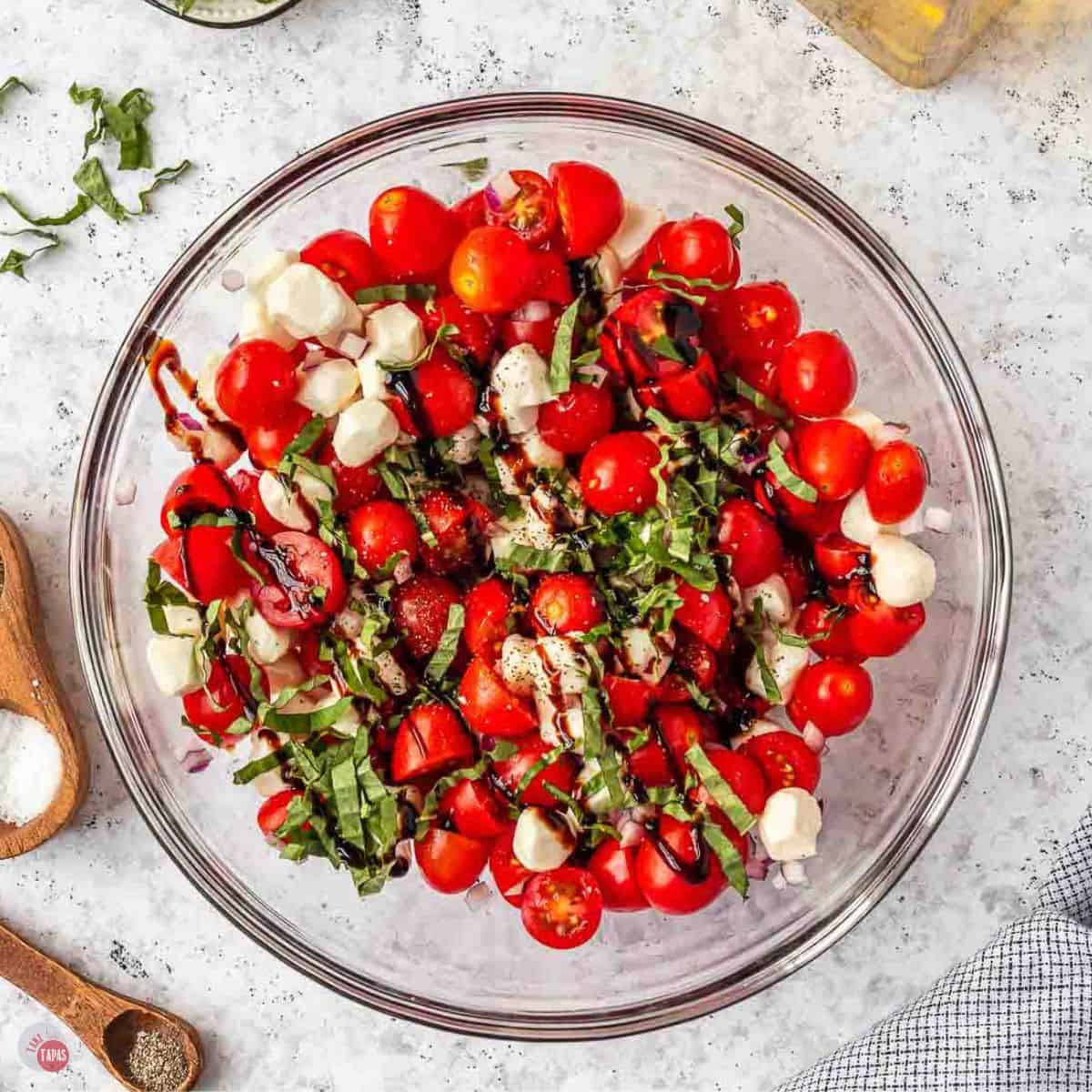 clear bowl of tomato, mozzarella, and fresh basil