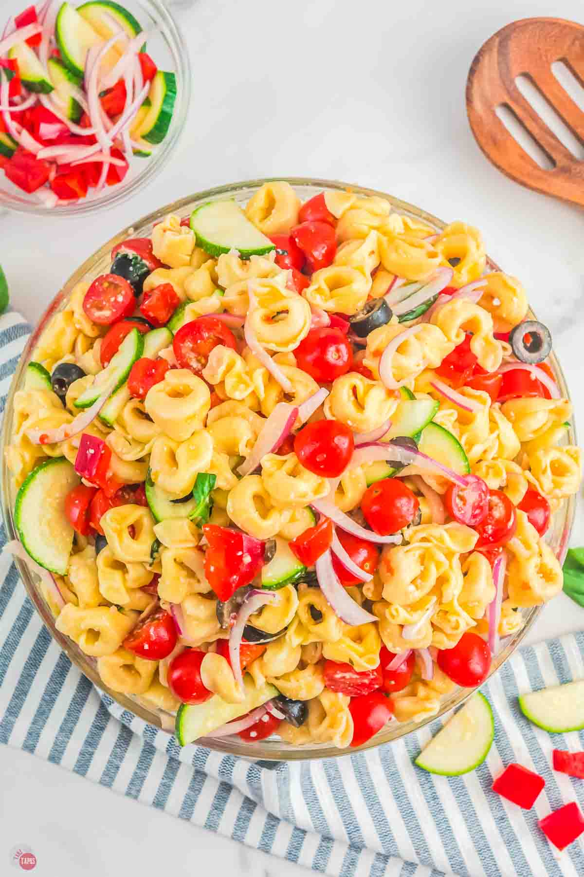 close up of tortellini pasta salad on a striped napkin