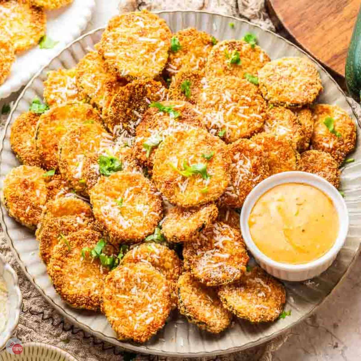 plate of air fryer zucchini chips with dipping sauce