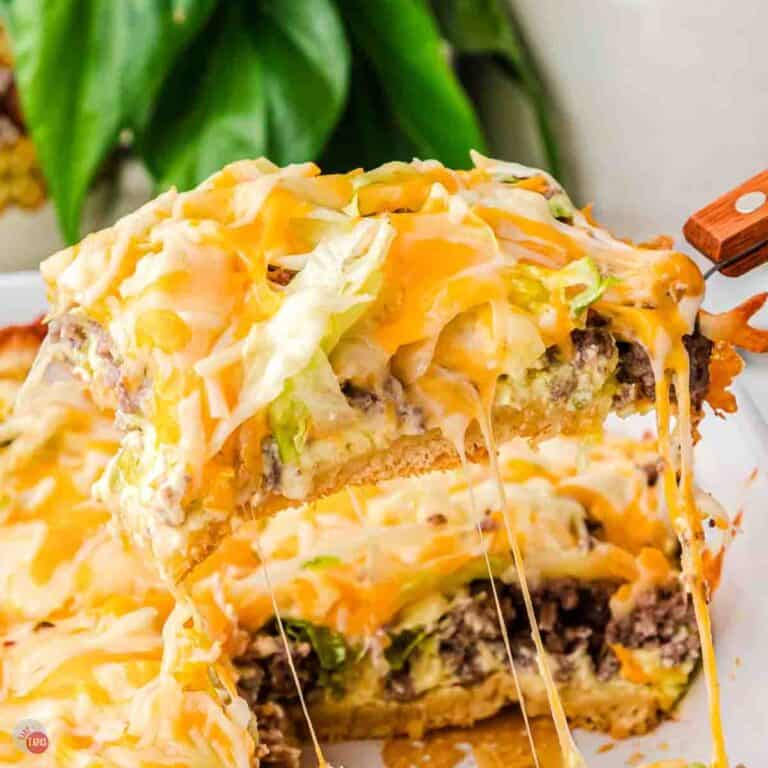 spatula lifting a section of casserole with melted cheese