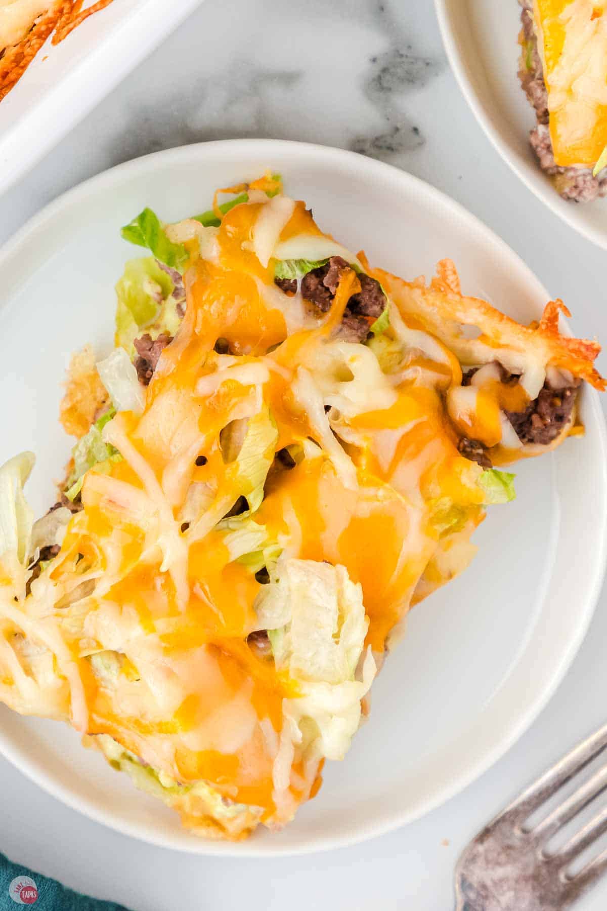 white plate with a square of casserole on top