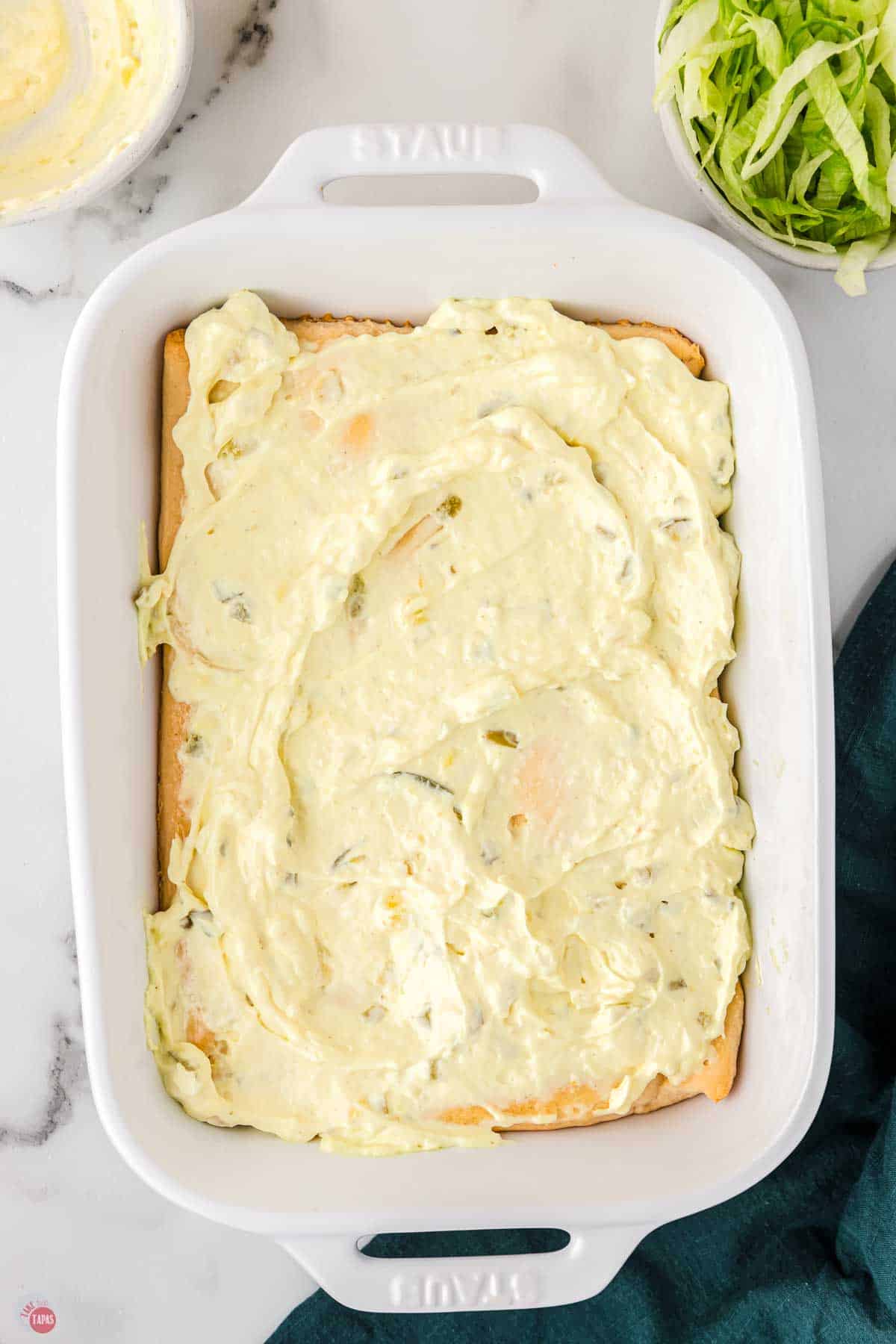 casserole dish with crust topped with tartar sauce
