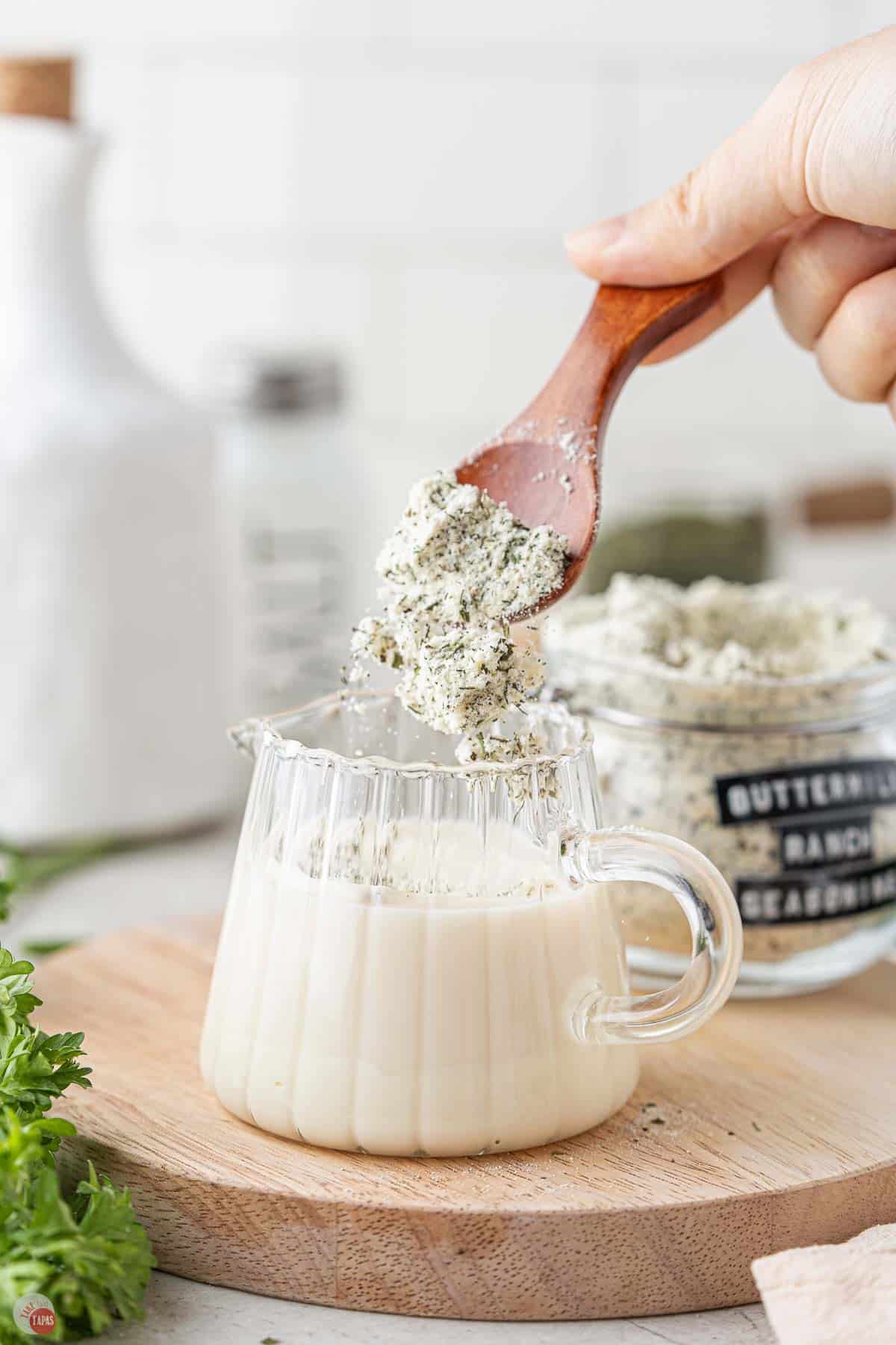 spices bring stirred into a small jar of dressing
