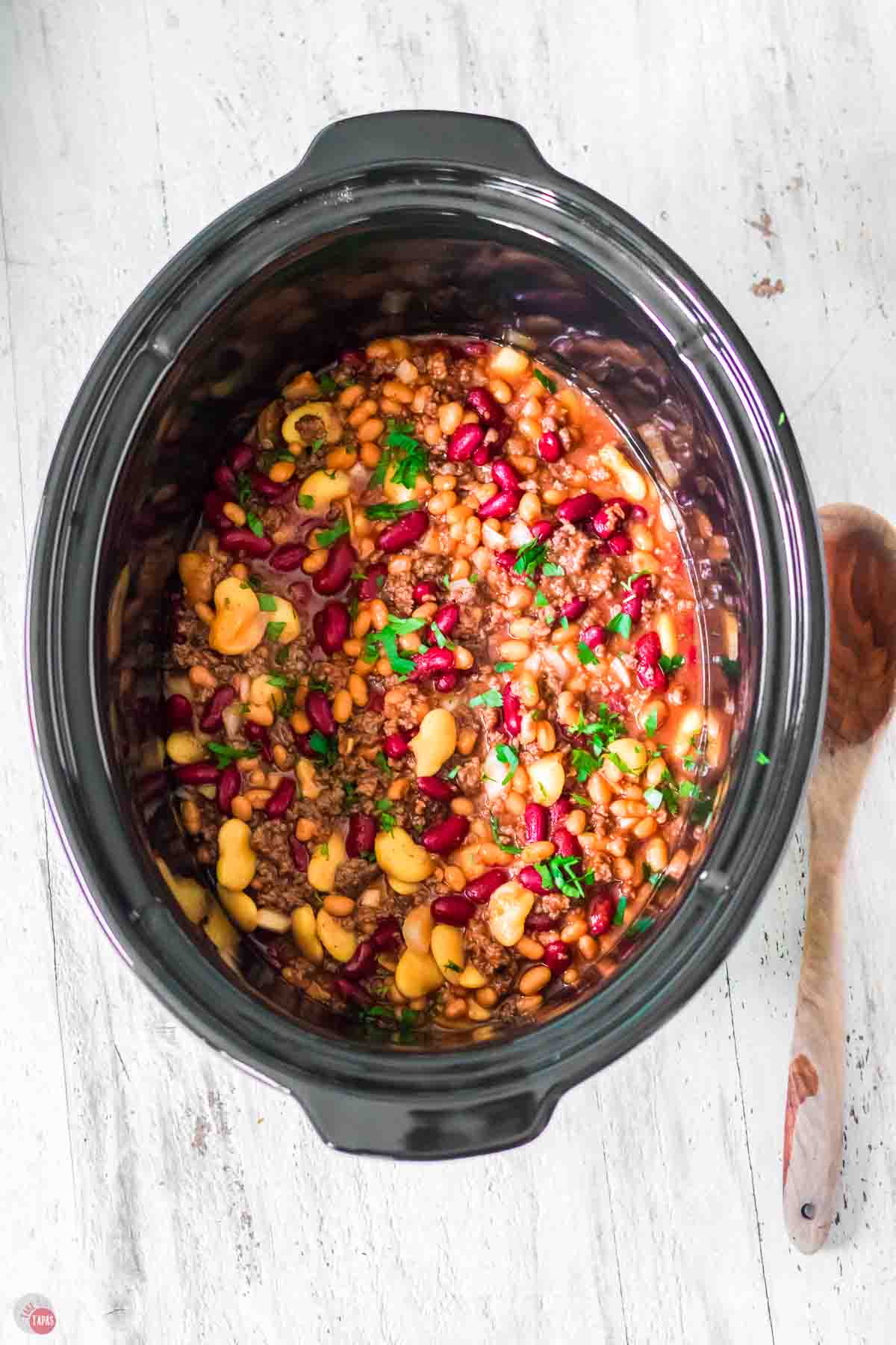 slow cooker bowl full of beans and meat
