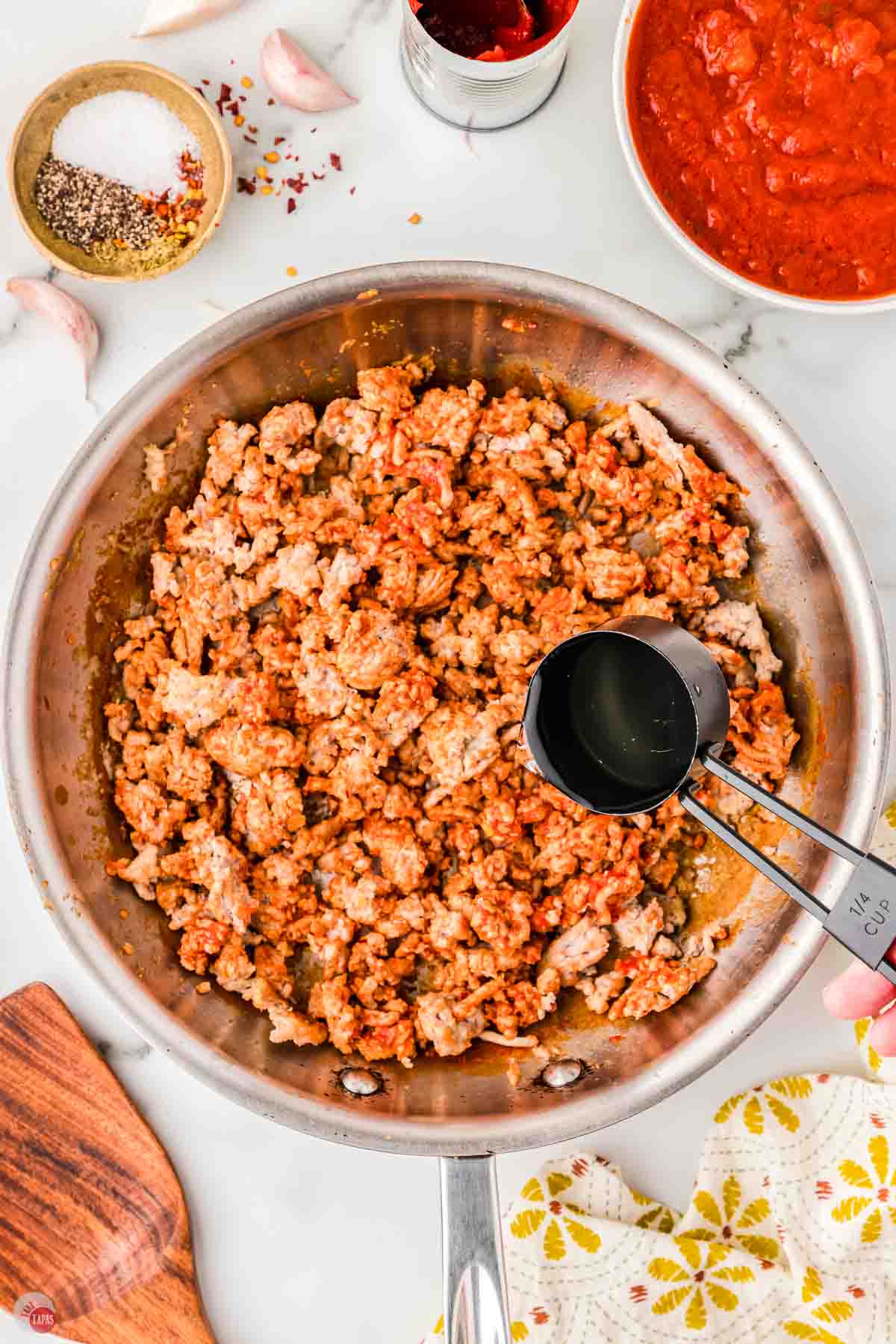 ground chicken cooking in a silver skillet