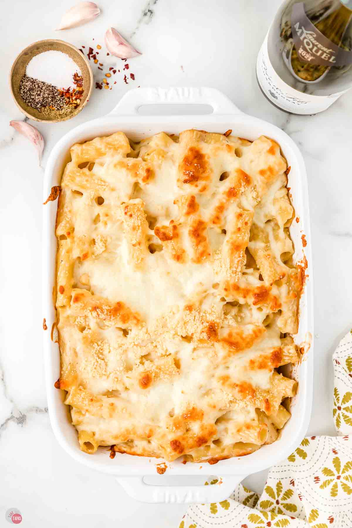 baked rigatoni alfredo in a white casserole dish