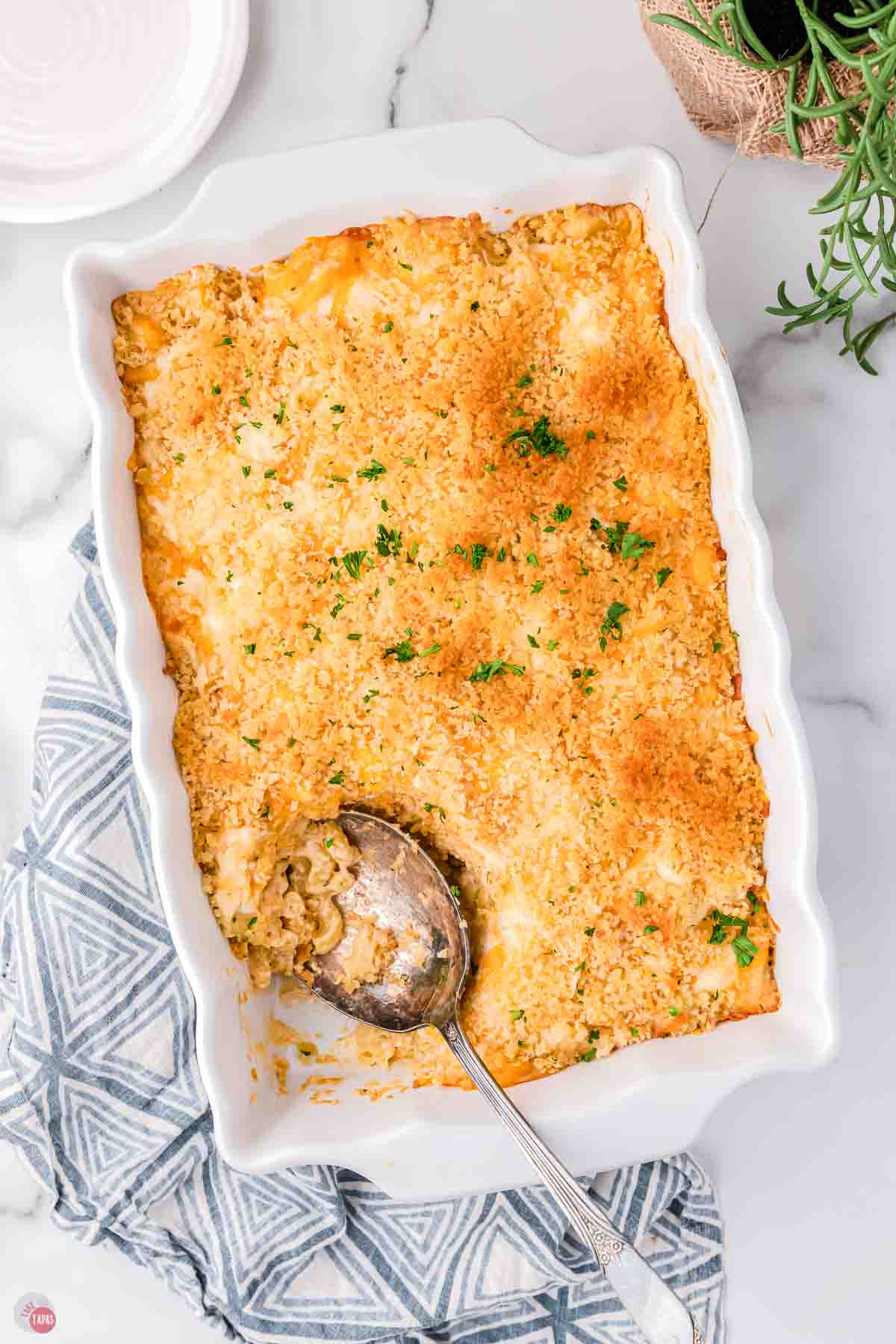 overhead picture of baked mac and cheese with a spoon in a removed scoop