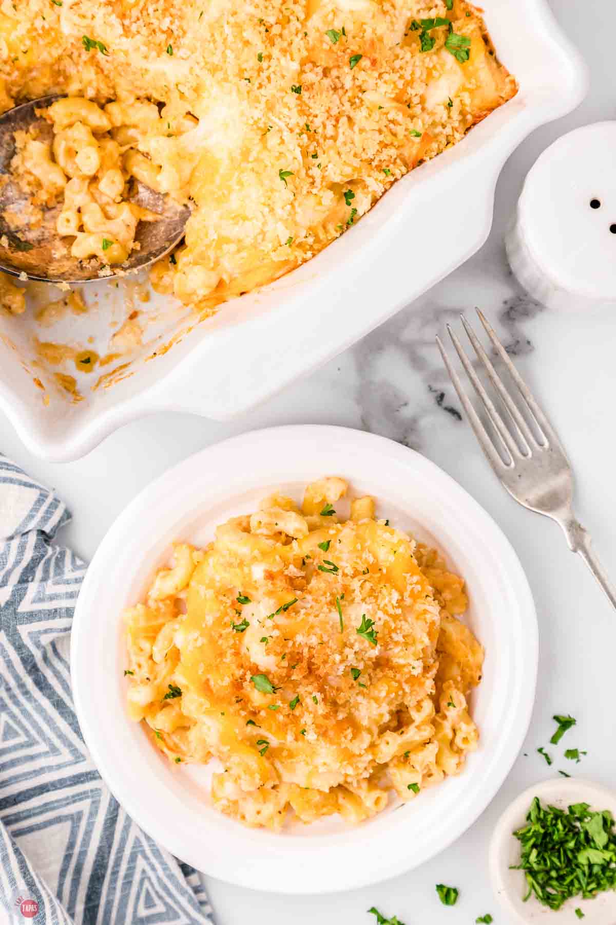 plate of cheesecake factory mac and cheese next to a casserole dish