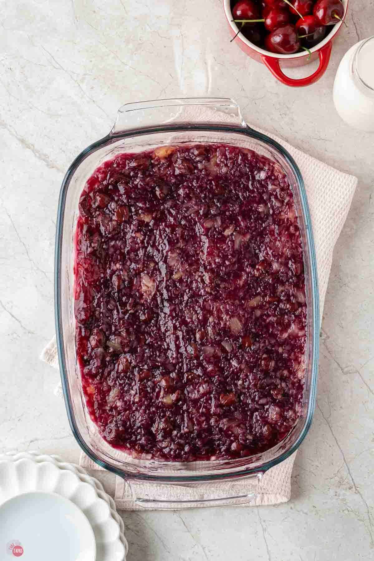 cherry dump cake fruit in a clear baking dish