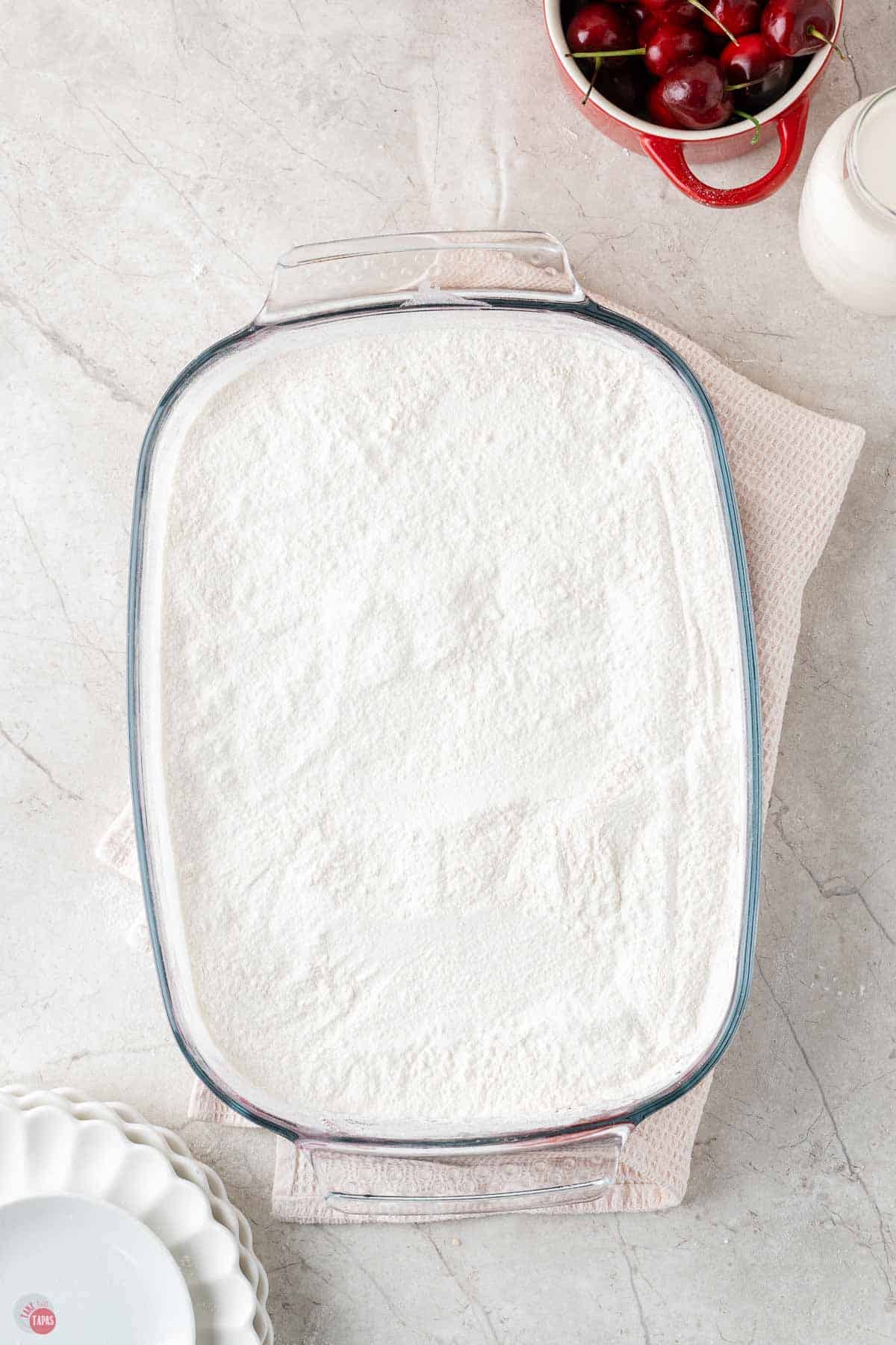 9x13 baking dish filled with vanilla cake mix powder