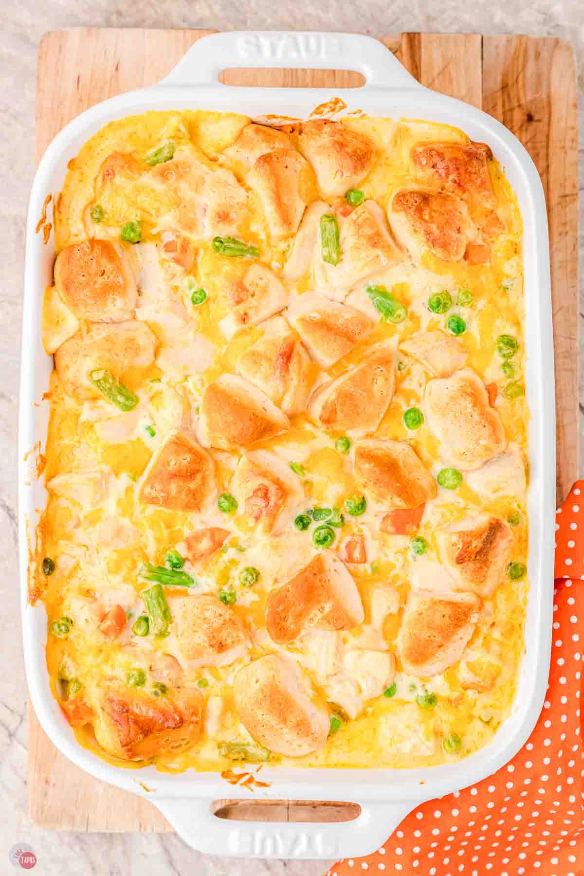 baked chicken bubble up casserole in a white dish