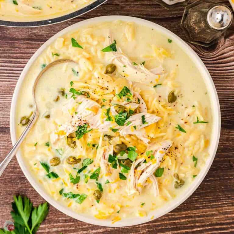 bowl of chicken piccata soup on a wood board