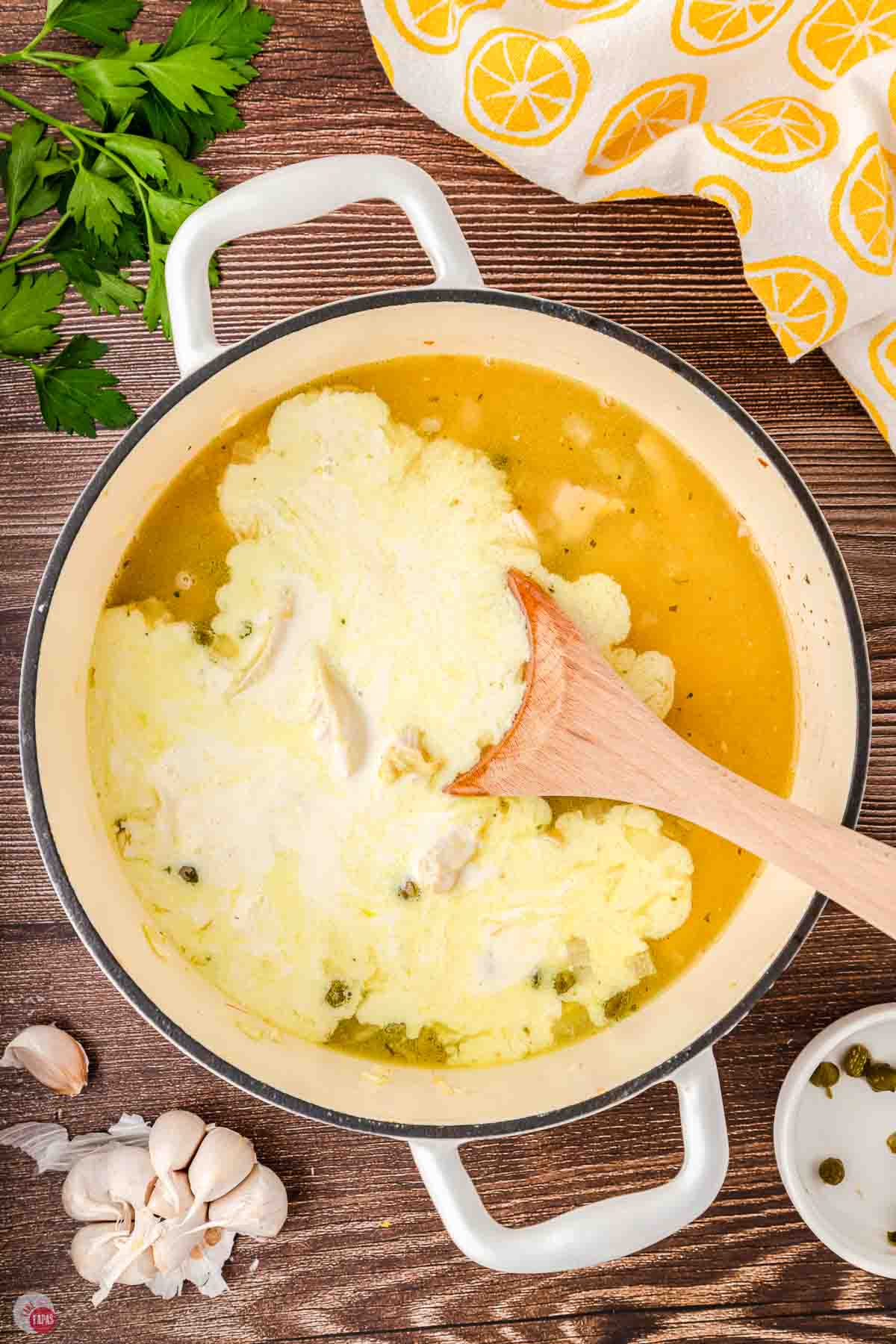 large pot of soup with cream just poured in