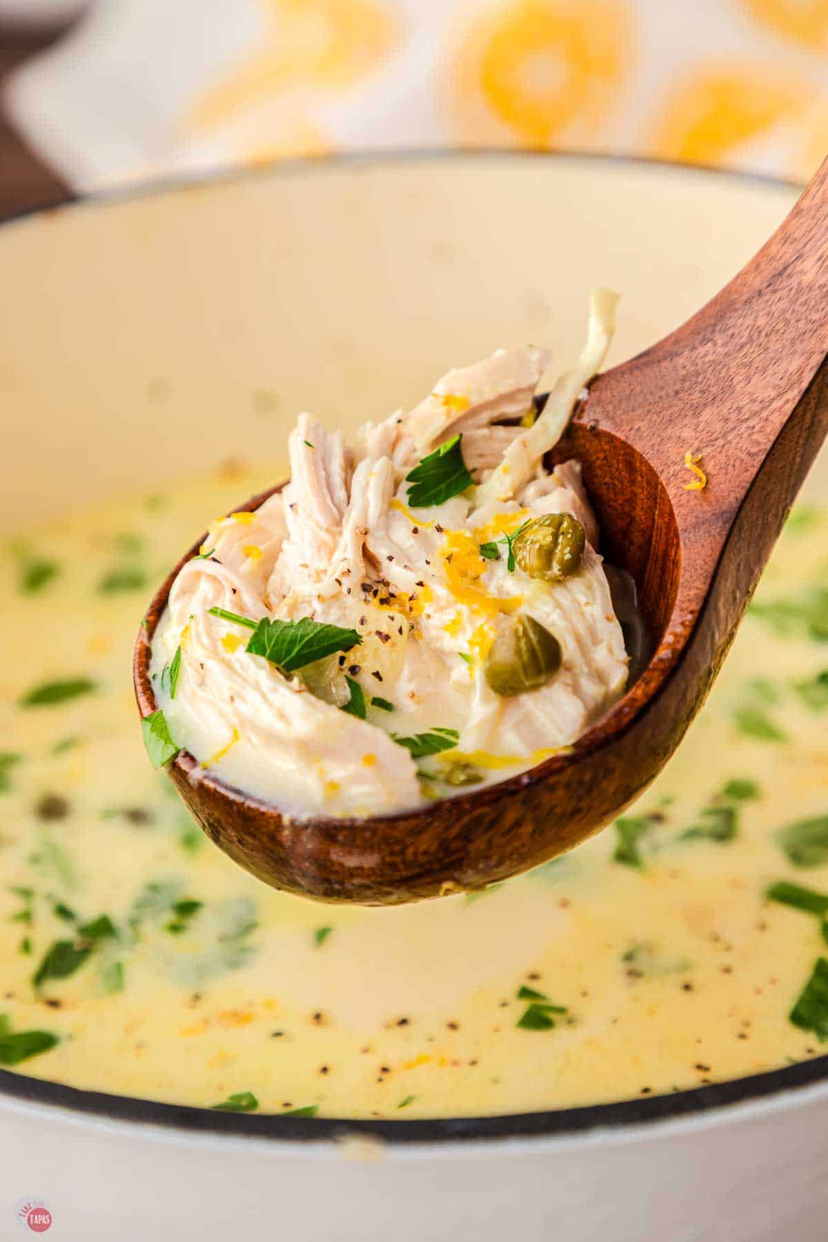 wood ladle full of soup