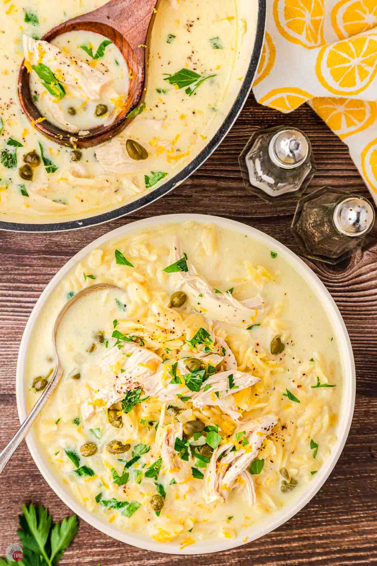 bowl of chicken piccata soup next to a pot