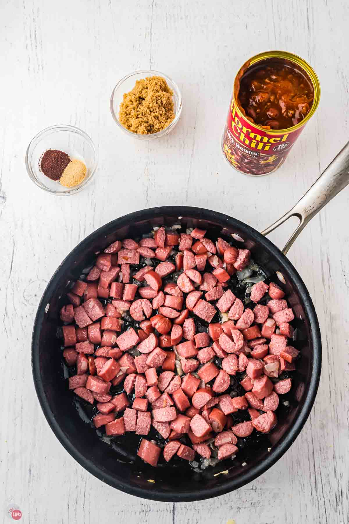 slices of hot dog cooking in a skillet