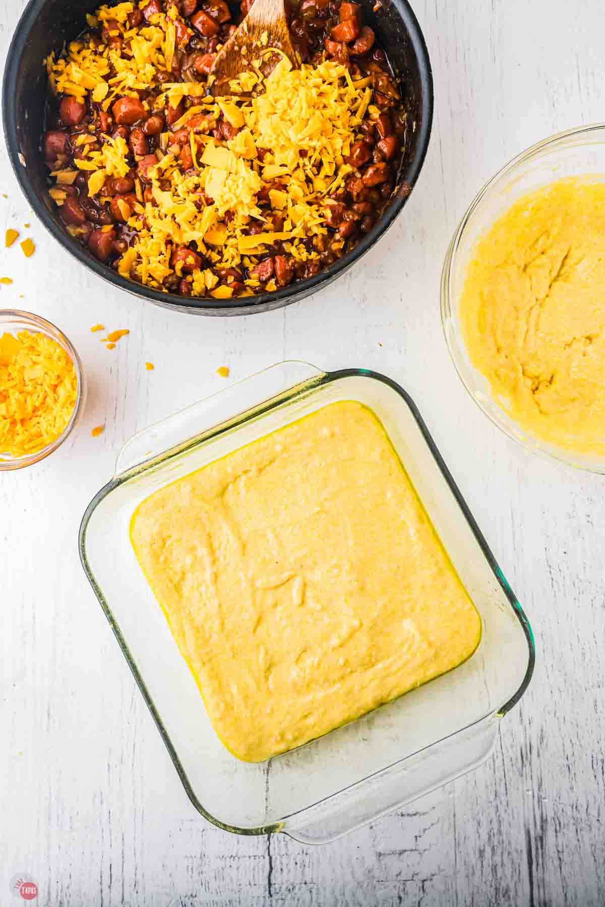 baking dish with cornbread batter in the bottom of it