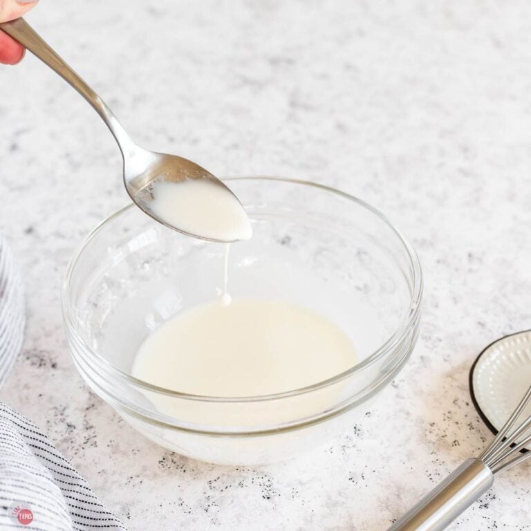 small clear bowl with a cornstarch slurry and a spoon