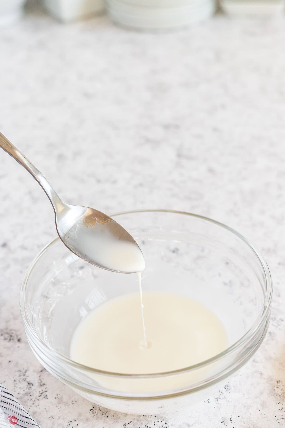 bowl of cornstarch and water mixed together with a spoon