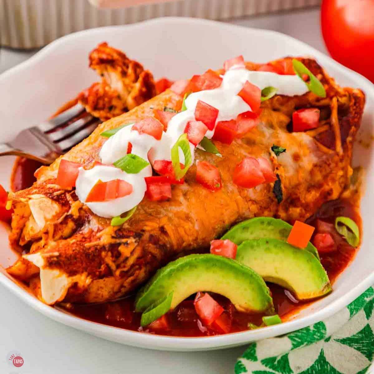 chicken enchilada in a bowl with sliced avocado