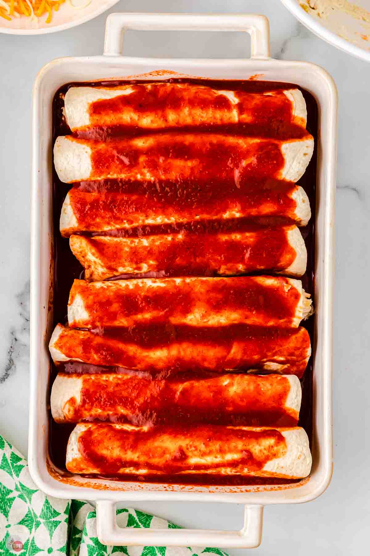 enchiladas rolled up in a baking dish topped with enchilada sauce