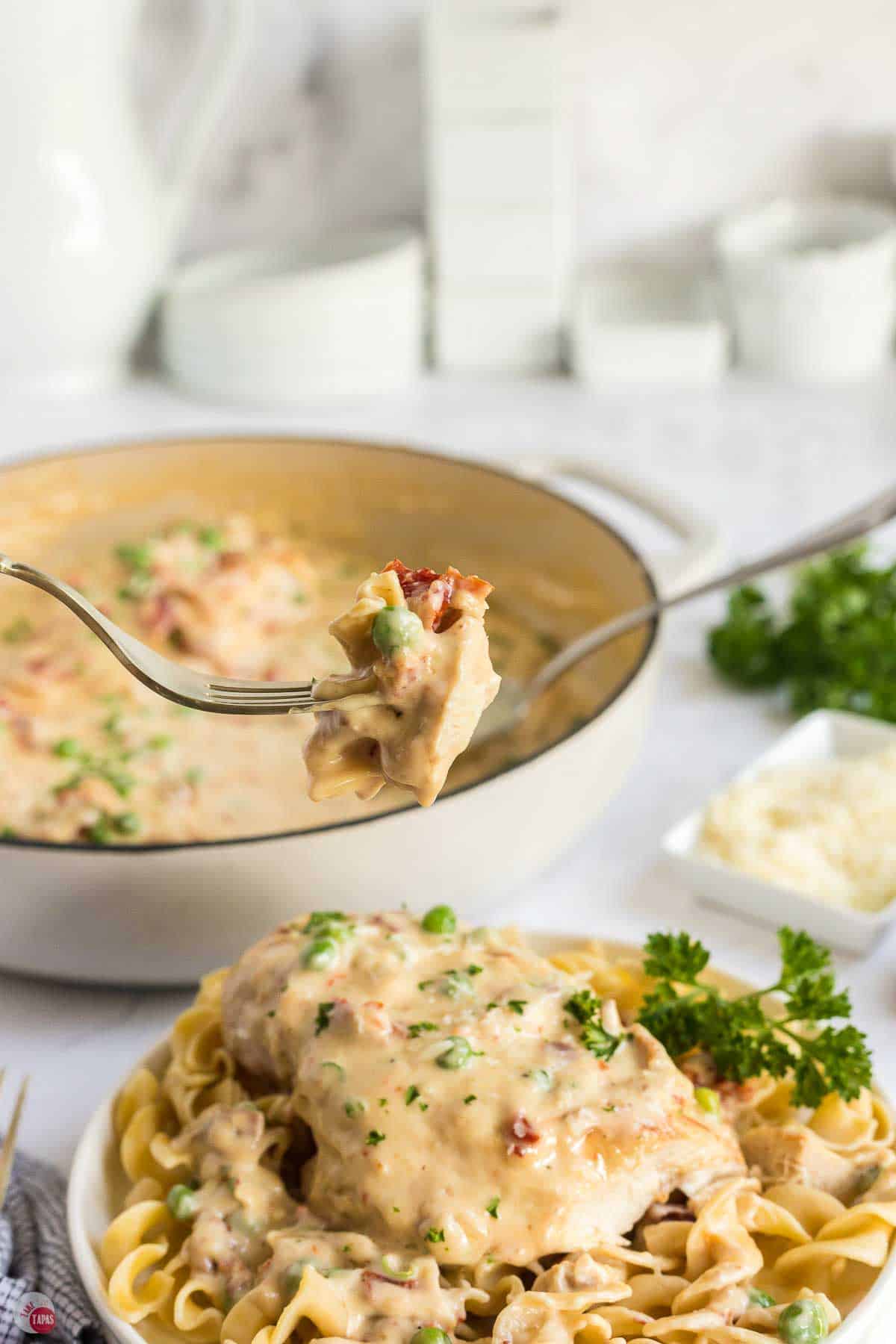 fork with bite of chicken and peas