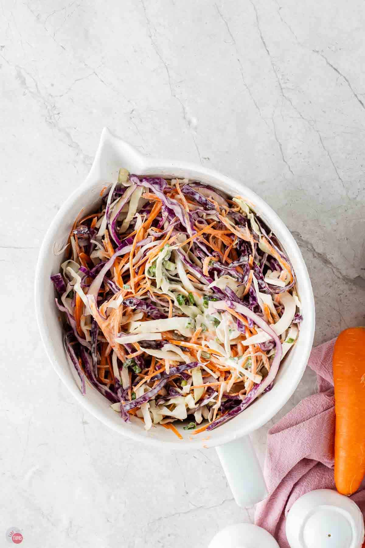 crunchy coleslaw in white mixing bowl