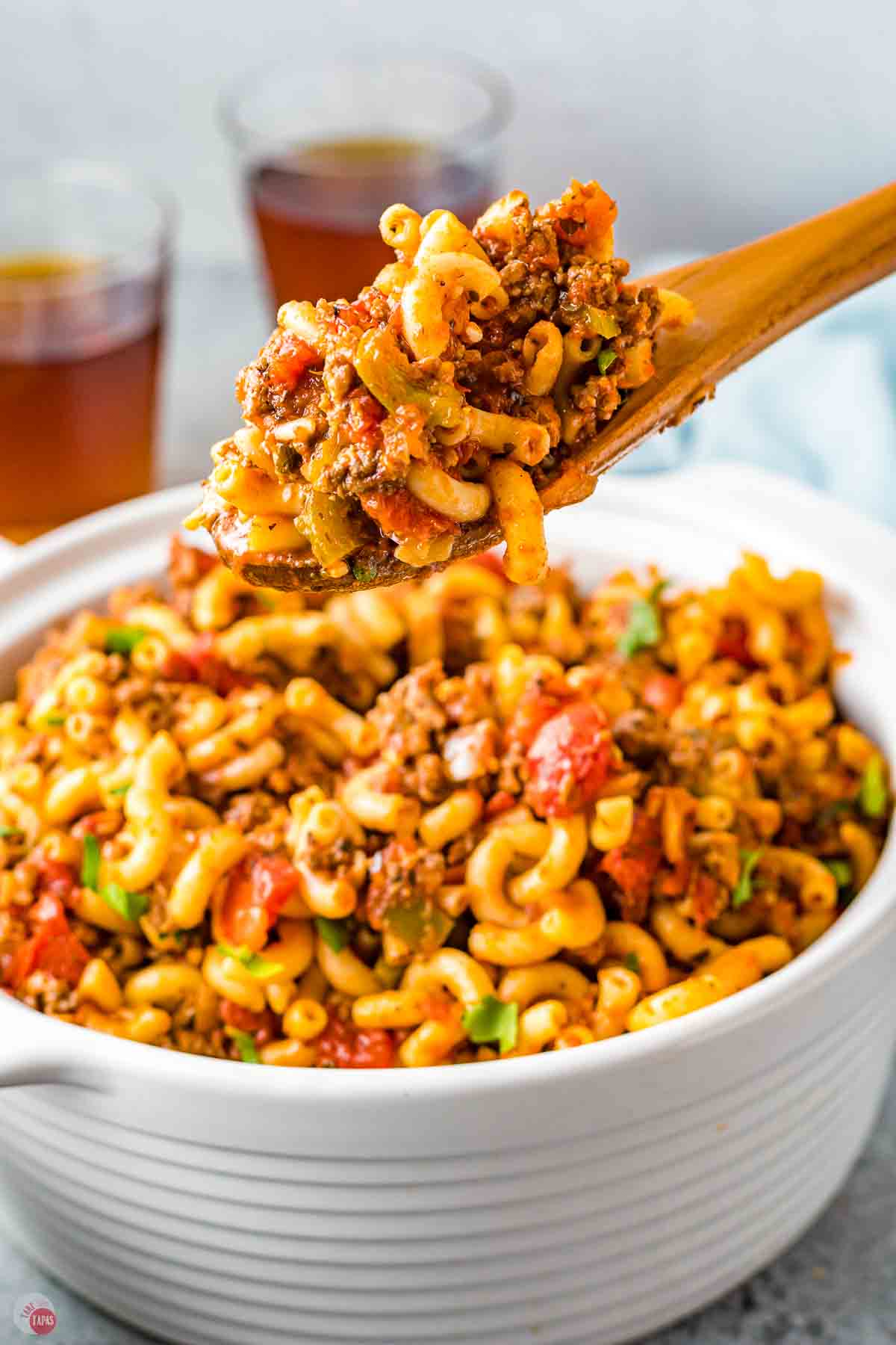 wood spoon with scoop of hamburger goulash