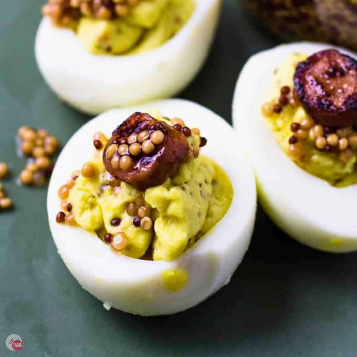 three honey mustard deviled eggs on a green plate