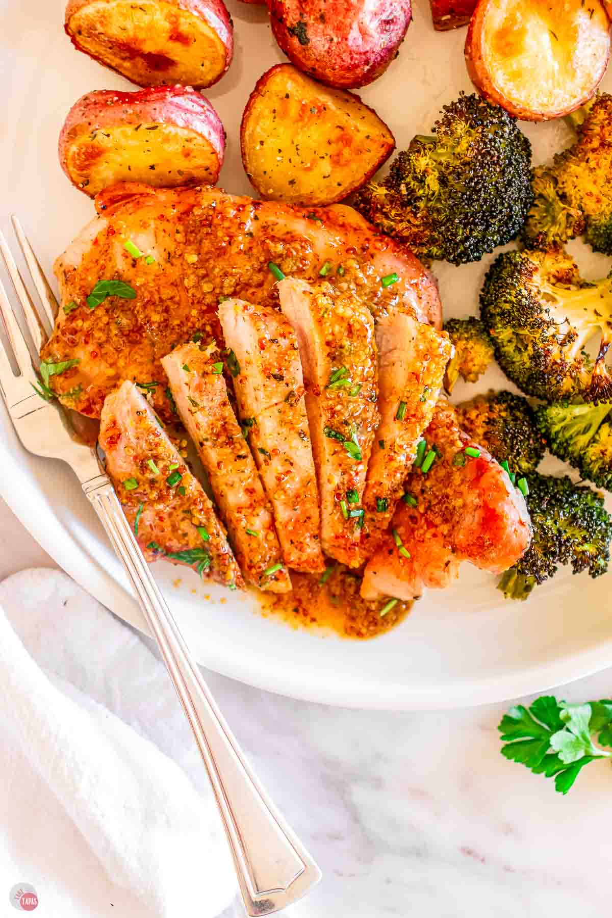 plate of honey mustard pork chops sliced into pieces